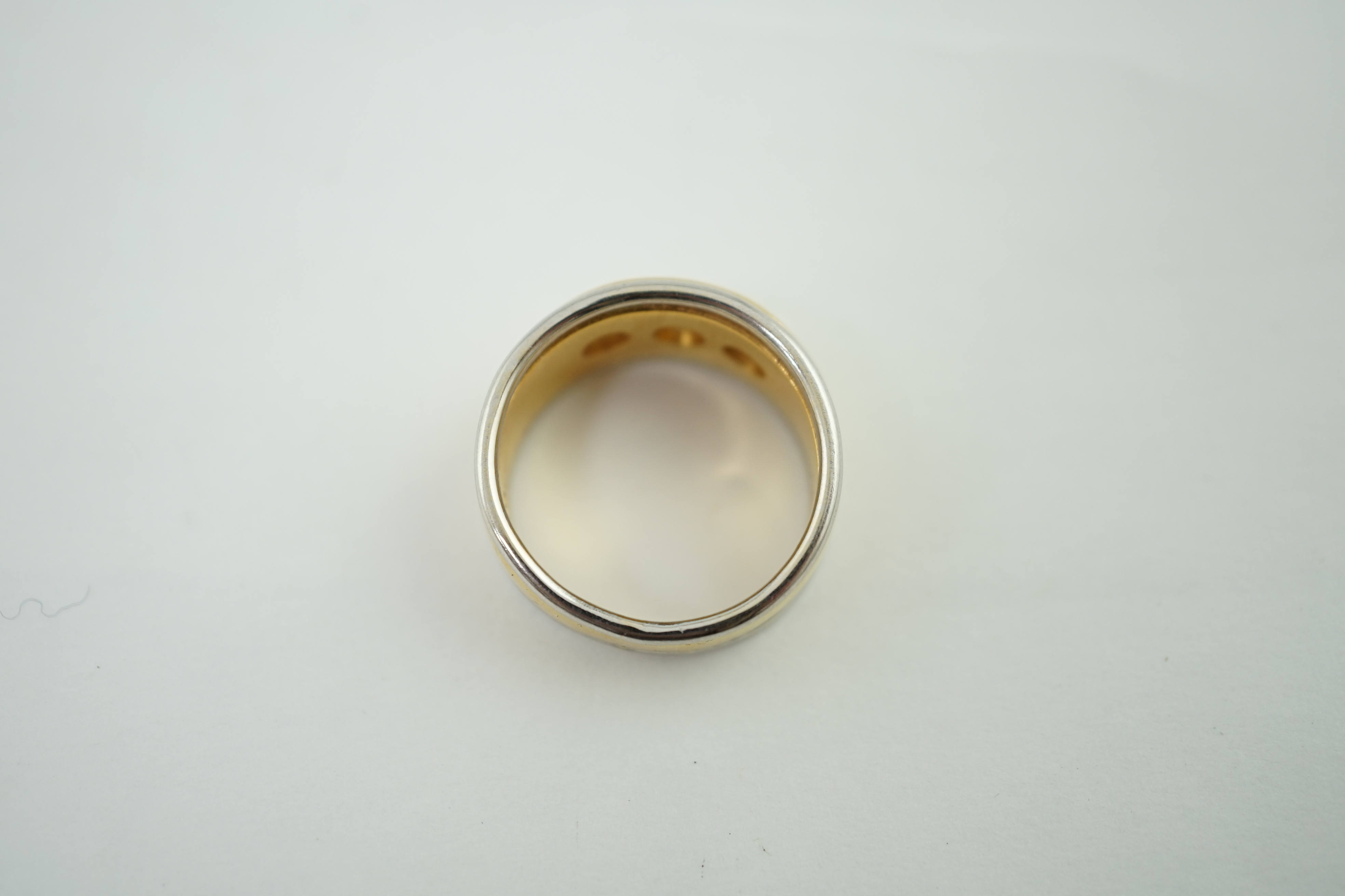 A 22ct gold and platinum gypsy set three stone diamond ring